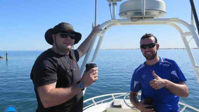 a man standing next to a body of water