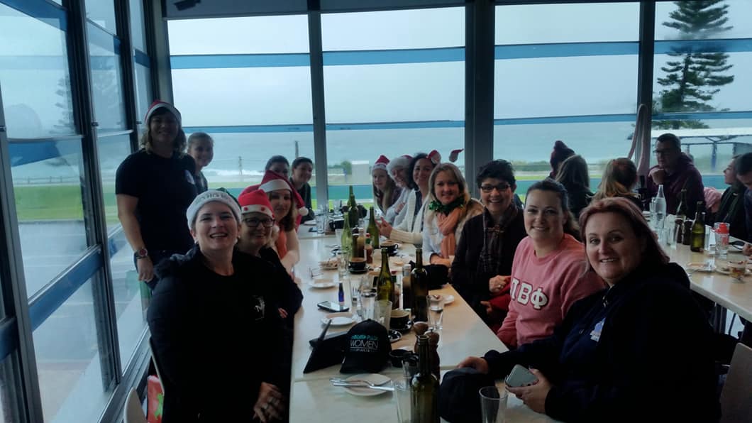 a group of people sitting at a table in front of a window