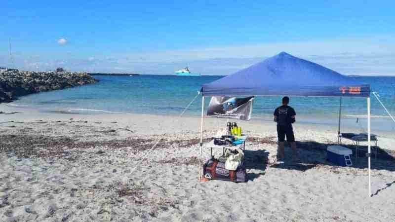 a group of people sitting at a beach