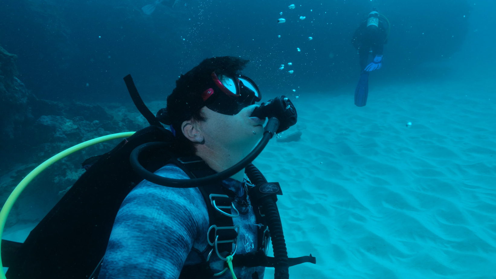 KAte diving a person swimming in the water