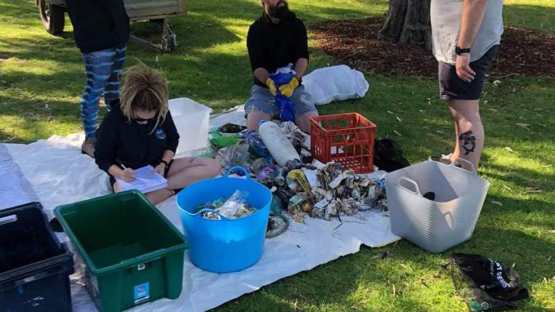 a group of people sitting at a park