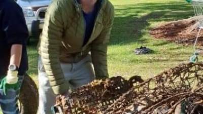 a man standing next to a tree