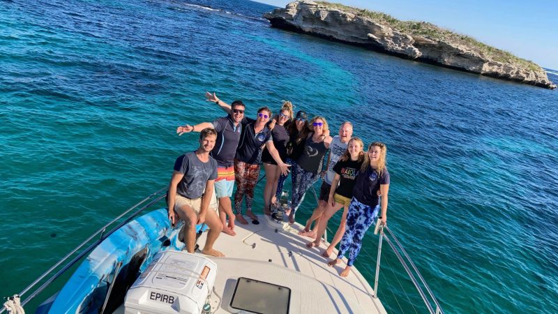 a group of people on a boat in the water