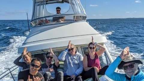 a group of people in a boat on a body of water