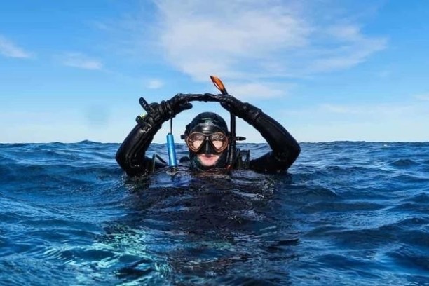 a person riding a surf board on a body of water