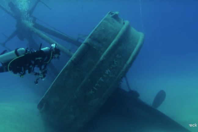 a deep shipwreck explore by a scuba diver